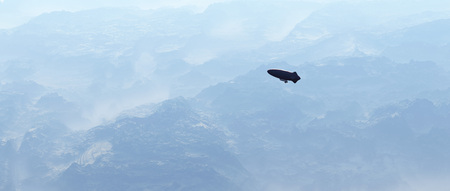 Aerial of zeppelin over misty rocky mountains.の写真素材