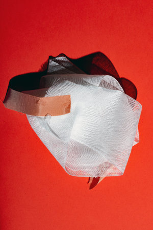 Bandage with tape on red. Top view.の写真素材