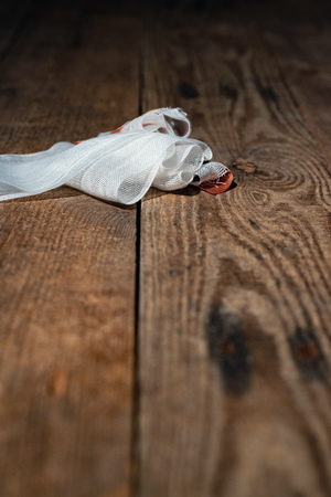 Bandage with tape fallen on wooden floor.の写真素材