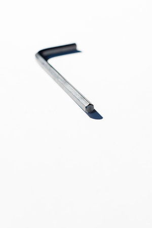 Hex key on white surface.