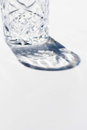 Vintage empty whiskey glass on white background.