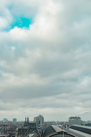 Central train station of the city of Amsterdam under cloudy sky in autumn. High angle view.の写真素材