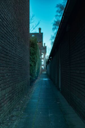 Dark abandoned alley in residential area.の写真素材