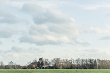 Historic dutch church in rural village in winter.