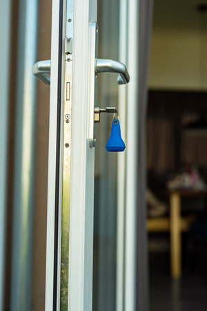 Key in the lock of an open door.