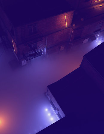 Aerial of a misty industrial alley with neon lights in the night. 3D render.の写真素材