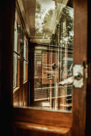 Open door in an interior of a historic train compartment.の写真素材