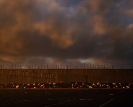 Parking with promenade at beach during sunset with a cloudy sky. Serene atmosphere. 3D rendering.の写真素材
