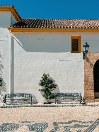 Typical Spanish Andalucian white yellow building in a village.