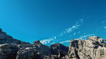 Majestic rock formations of limestone under blue sky with little clouds. National park of El Torcal de Antequera. Andalucia, Spain.の写真素材