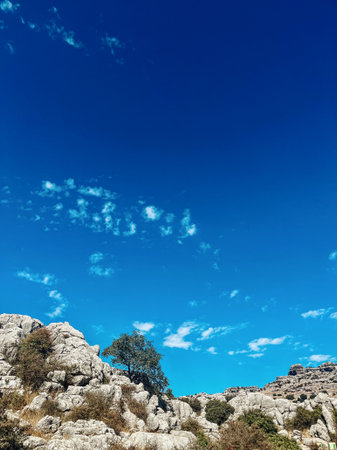 Majestic rock formations of limestone under blue sky with little clouds. National park of El Torcal de Antequera. Andalucia, Spain.の写真素材