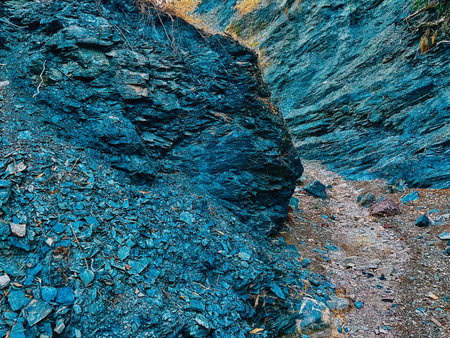Bluish rock walls in gorge with some vegetation. Organic shapes.の写真素材