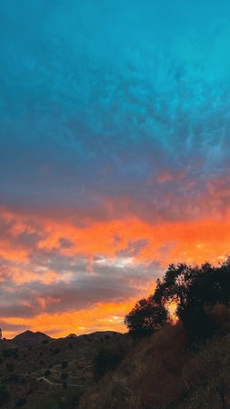 Rolling landscape with hills and olive trees during sunset in countryside of Malaga, Andalucia, Spain.の写真素材