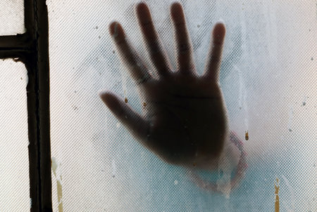 A girl hand behind the blur glass
