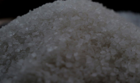 Close-up of sea salt in a bowl on black background.の写真素材