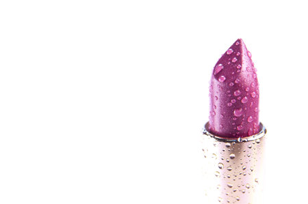 Fashionable moisturizing pink purple lipstick with water dropletsの写真素材