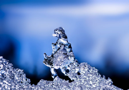 natural ice sculpture with a blue sky with clouds in the background