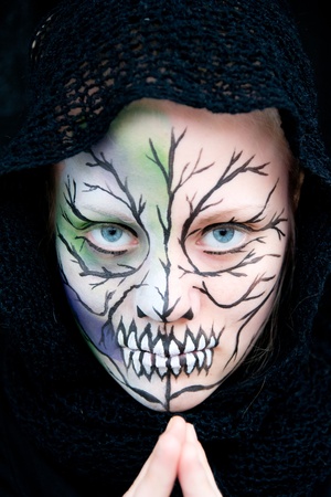 young woman who looks dangerous and crazy with Halloween face paintingの写真素材