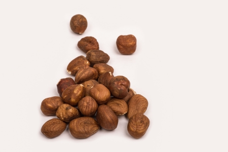 a pile of shelled hazelnuts on a white backgroundの写真素材