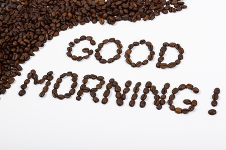 good morning written with coffee beans on a white backgroundの写真素材
