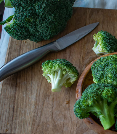 pieces of broccoli on a wooden board, close - up
