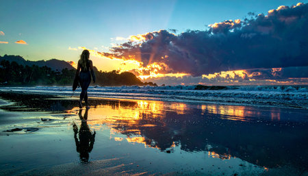 A woman walks along the beach at sunset with golden reflections on the wet sand, capturing serene coastal beauty in Ai-Generated.の素材