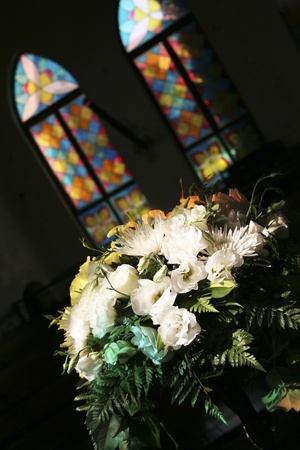 Flowers in front of colorful stained glass windowsのeditorial素材