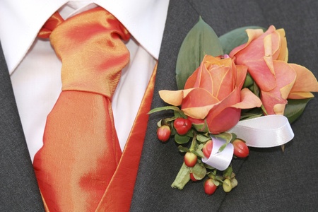 Groom's orange tie and rosesの写真素材