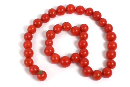 Red cocktail tomatos in the shape of an @ signの写真素材