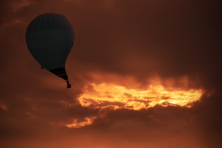 Hot air balloon sucked into black hole. Abstract work.の写真素材