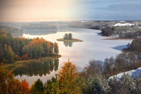 Lake Jedzelwo in autumn  and winter. Composition fifty fifty. Masuria, Stare Juchy, Poland.の写真素材