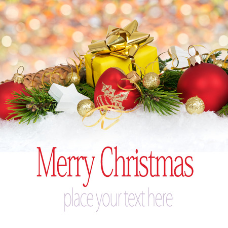 Christmas decoration with balls, stars, cones and gift on artificial snow flakes. Copy space.の写真素材
