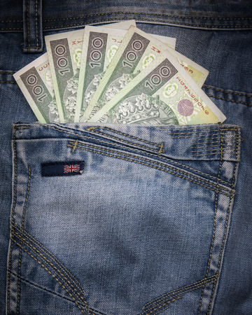 Several polish 100 zloty banknotes in english jeans.の写真素材