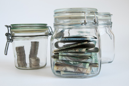 Money stored in sealed retro jars.の写真素材