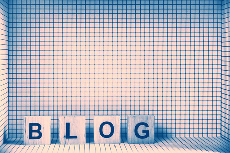 Word "BLOG" made of wooden letters, placed in 3D checkered frame. Retro stylized.の写真素材