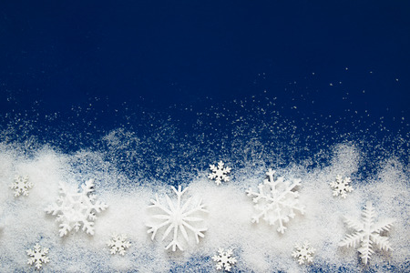 Christmas background with a decorative snowflake on artificial snowの写真素材