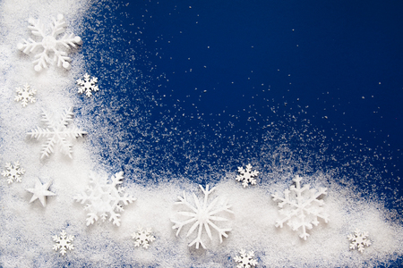 Christmas background with a decorative snowflake on artificial snowの写真素材