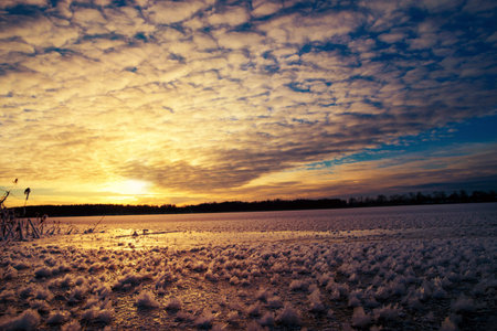 Pieces of frost on frozen Lake Elckie, lit by the setting sun. Winter landscape. Masuria, Poland.の写真素材