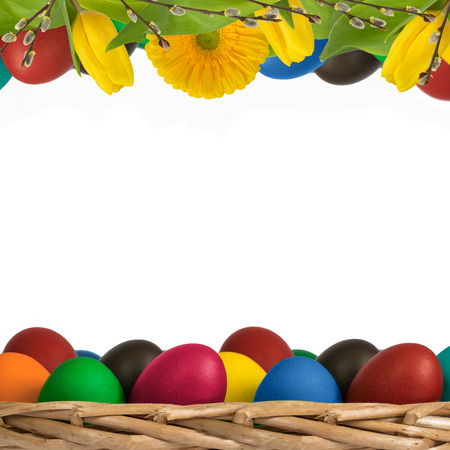 Easter square decoration with eggs on wicker basket, tulips,  gerbera and catkins on white background.の写真素材