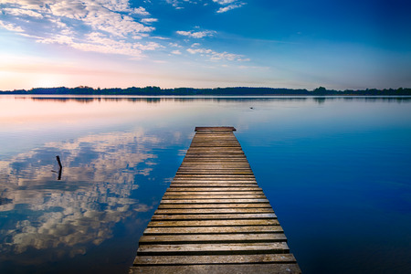 Empty footbridge over the lake Selment Wielki. Masuria, Poland.の写真素材