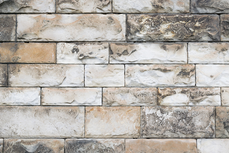 Bumpy ancient wall. Texture of tiles of different sizes.の写真素材