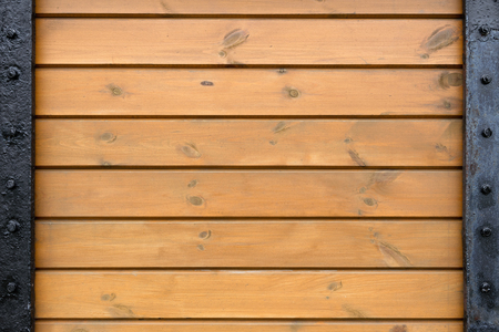 Boards screwed to steel plates. Metal and wood texture.の写真素材