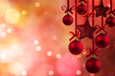 Christmas red balls with ribbons isolated on defocused backgroundの写真素材