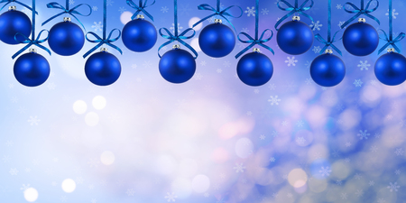 Christmas blue balls with ribbons isolated on defocused backgroundの写真素材