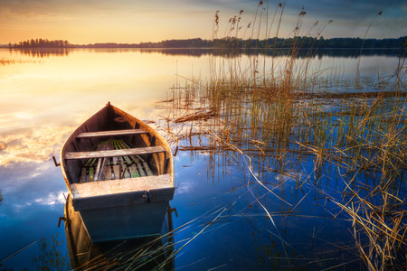 Rowing boat floating over the Lake Selment Wielki waters. Masuria, Poland.の写真素材