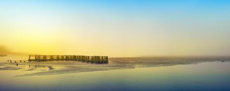 Panorama of the Elckie Lake shrouded in fog. Masuria, Poland.の写真素材