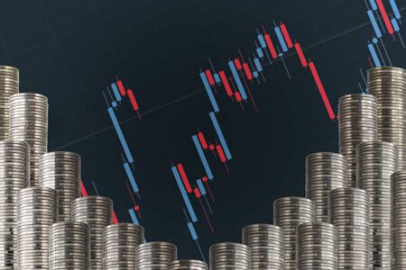 Rows of silver coins with a graph.の写真素材