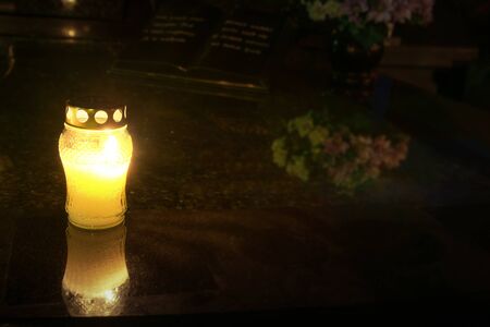 Burning candles at a cemetery before All Saints Day (1st November).の写真素材