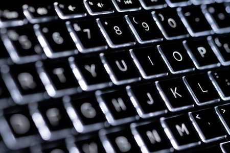 Illuminated, defocused laptop keyboard. Informatics background.の写真素材