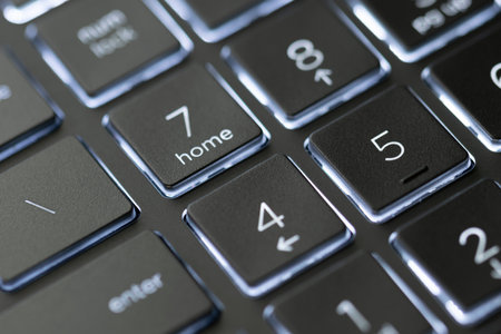Illuminated, defocused laptop keyboard. Informatics background.の写真素材